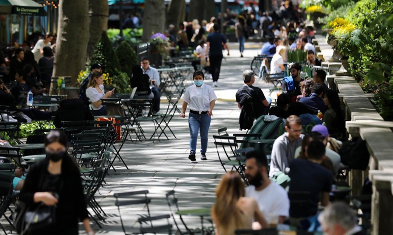 A woman walks through Bryant Park in New York, the United States, May 14, 2021. The U.S. Centers for Disease Control and Prevention (CDC) will no longer recommend masks for fully-vaccinated Americans indoors or outdoors, including in crowds, according to its new guidance announced on Thursday.Photo:Xinhua