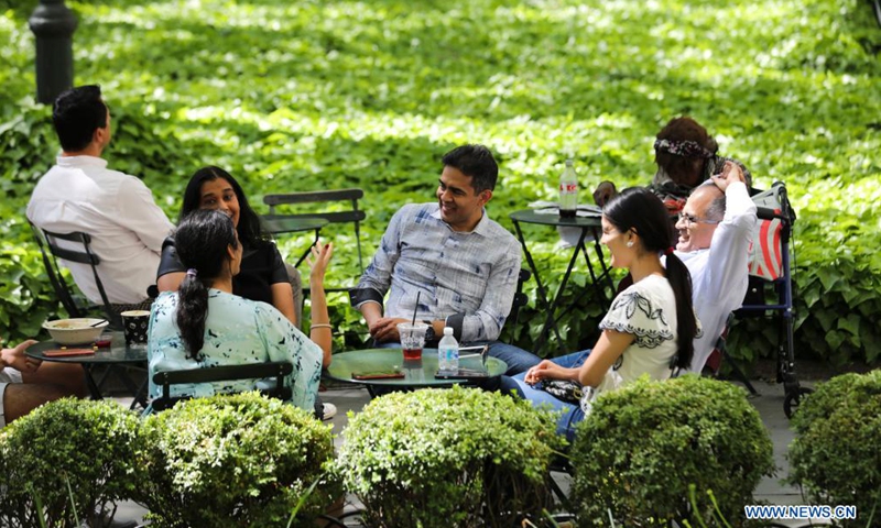 People enjoy themselves in Bryant Park in New York, the United States, May 14, 2021. The U.S. Centers for Disease Control and Prevention (CDC) will no longer recommend masks for fully-vaccinated Americans indoors or outdoors, including in crowds, according to its new guidance announced on Thursday.Photo:Xinhua