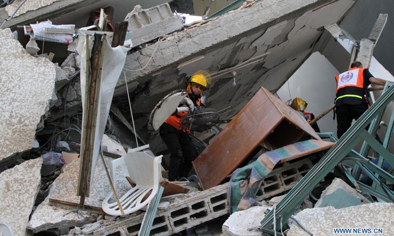 Rescuers check rubbles of Jala Tower, which housed offices of Al-Jazeera TV and Associated Press as well as residential apartments, after it was hit by an Israeli airstrike in Gaza City, on May 15, 2021. Israel said Saturday it struck the high-rise building in Gaza City housing offices of international media outlets because it contained assets of Hamas intelligence agency. (Photo: Xinhua)
