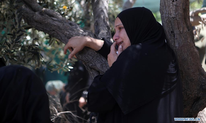 A relative of Palestinian Wagdi Jaafara, 30, who was killed during clashes with Israeli soldiers near Al-Fawwar refugee camp, mourns during his funeral in Tarqumiya village, northwest of the West Bank city of Hebron, May 16, 2021.(Photo: Xinhua)