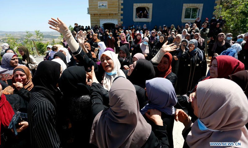 The mother (C) of Palestinian Yassin Hamad who was killed during clashes with Israeli soldiers, mourns during his funeral in Seida village, north of the West Bank city of Nablus, May 16, 2021.(Photo: Xinhua)
