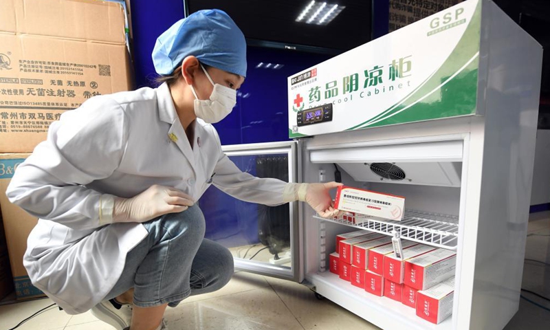 A medical worker takes out the recombinant COVID-19 vaccine (adenovirus type 5 vector) which requires only one shot from a cooler at a temporary vaccination site in Haidian District of Beijing, capital of China, May 20, 2021.Photo:Xinhua