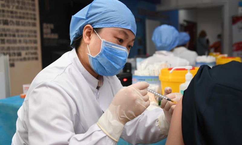 A medical worker administers a dose of the recombinant COVID-19 vaccine (adenovirus type 5 vector) which requires only one shot to a resident at a temporary vaccination site in Haidian District of Beijing, capital of China, May 20, 2021.Photo:Xinhua