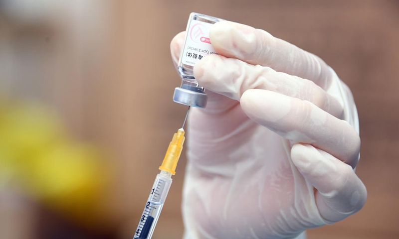 A medical worker prepares to administer a dose of the recombinant COVID-19 vaccine (adenovirus type 5 vector) which requires only one shot at a temporary vaccination site in Haidian District of Beijing, capital of China, May 20, 2021.Photo:Xinhua