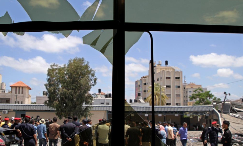 People gather in front of the governmental building damaged by Israeli airstrikes in Gaza city, on May 22, 2021.Photo:Xinhua