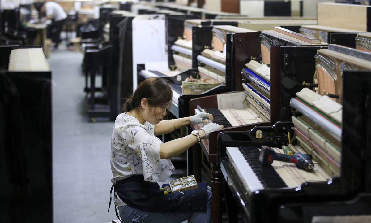 A worker tunes the piano in a factory in Luoshe town, East China’s Zhejiang Province. Photo: Yang Hui/GT 