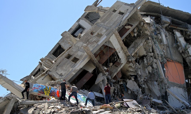 Palestinians inspect the rubbles of the Al-Shorouq Tower destroyed by Israeli airstrikes, in Gaza City, on May 23, 2021.(Photo: Xinhua)