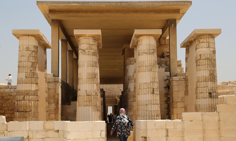 Tourists visit the Step Pyramid complex in the Saqqara necropolis near the capital Cairo, Egypt, May 26, 2021. The Step Pyramid, a UNESCO World Heritage Site, was designed and built by the architect Imhotep in the 27th century BC during the Third Dynasty to hold the mummy of Pharaoh Djoser.(Photo: Xinhua)