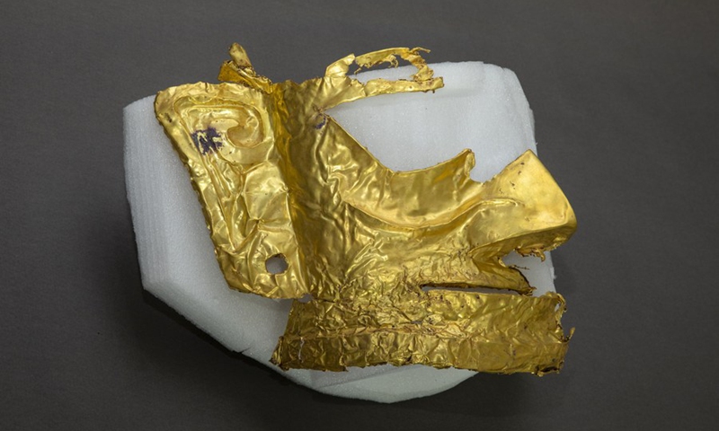 Photo taken on March 17, 2021 shows a broken gold mask unearthed from a sacrificial pit at the Sanxingdui Ruins site in southwest China's Sichuan Province.(Photo: Xinhua)