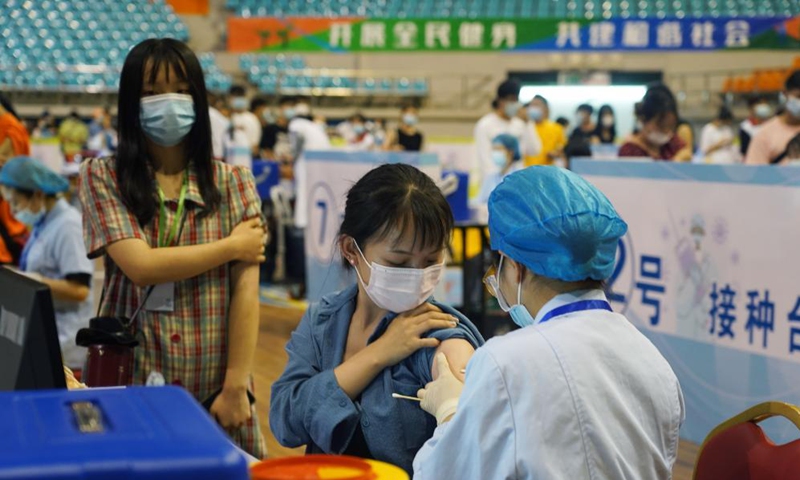 A medical worker administers a COVID-19 vaccine to a college student in Nanchang, capital of east China's Jiangxi Province, June 4, 2021. A temporary vaccination site is newly set at a stadium, with daily inoculation capacity of about 5,000. Photo: Xinhua