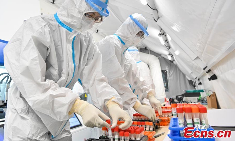 Medical staffs check nucleic acid test samples in an air-inflated mobile COVID-19 test lab set up in Guangzhou Gymnasium, Guangzhou, capital city of south China’s Guangdong Province, June 3, 2021.Photo:China News Service