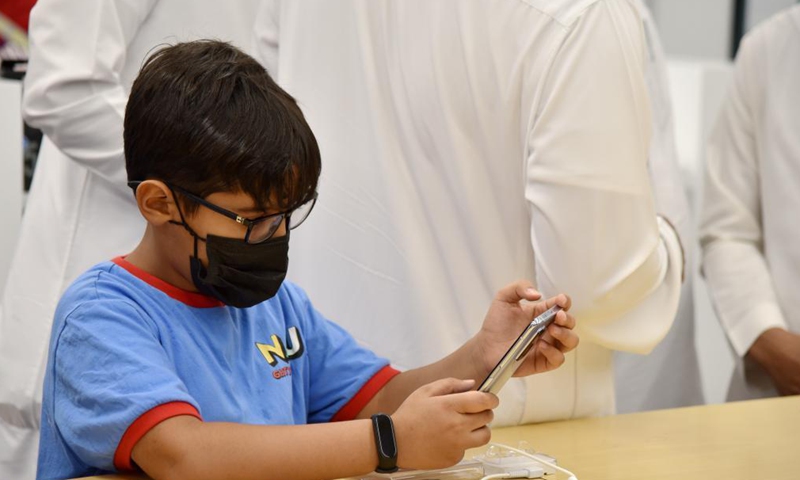 A boy tries new features of Xiaomi's smartphone at the Mi-store in the Electron Commercial Center in Riyadh, Saudi Arabia, on June 4, 2021. China's tech company Xiaomi, known for its smartphones, opened its first Mi-store in Saudi Arabia on Thursday. Photo:Xinhua