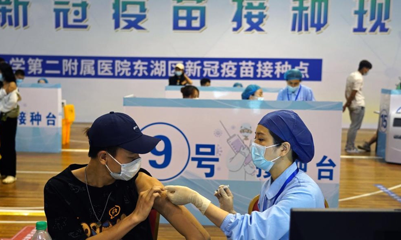 A medical worker administers a COVID-19 vaccine to a college student in Nanchang, capital of east China's Jiangxi Province, June 4, 2021. A temporary vaccination site is newly set at a stadium, with daily inoculation capacity of about 5,000. Photo: Xinhua