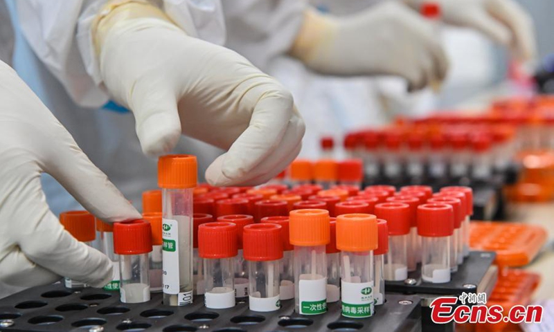 Medical staffs check nucleic acid test samples in an air-inflated mobile COVID-19 test lab set up in Guangzhou Gymnasium, Guangzhou, capital city of south China's Guangdong Province, June 3, 2021.Photo:China News Service