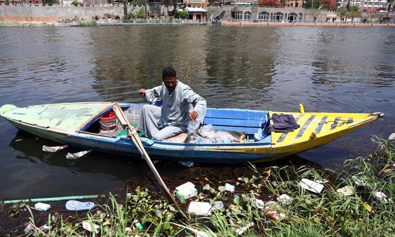 A fisherman financially empowered by VeryNile collects plastics from the Nile River in Cairo, Egypt, June 5, 2021. (Photo: Xinhua)