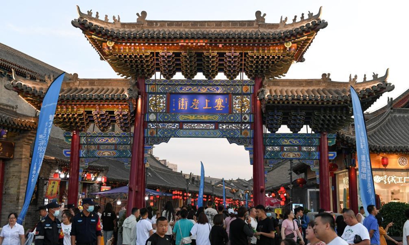 Tourists visit an old street in Hohhot, north China's Inner Mongolia Autonomous Region, June 10, 2021. Various activities such as appreciating traditional music and tasting local food are held here to promote tourism.  Photo: Xinhua