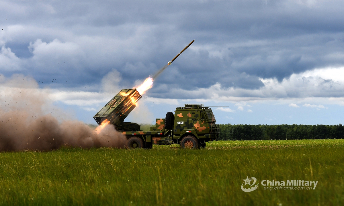 A wheeled long-range multiple launch rocket system (LRMLRS) attached to a brigade under the PLA 80th Group Army fires rockets during a live-fire drill on June 4, 2021. (eng.chinamil.com.cn/Photo by Guo Daoxiong)
