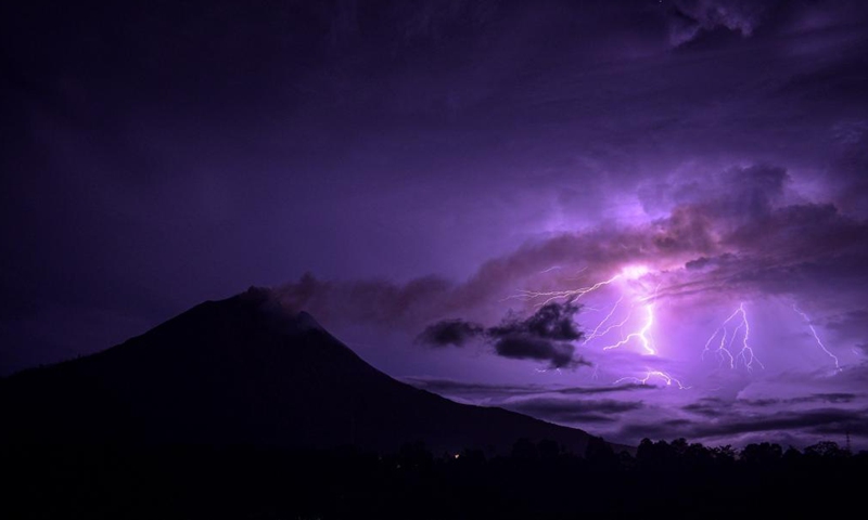 This long-time exposure photo taken on June 12, 2021 shows lightning striking near Mount Sinabung in North Sumatra, Indonesia. (Photo by Sarianto Sembiring/Xinhua)