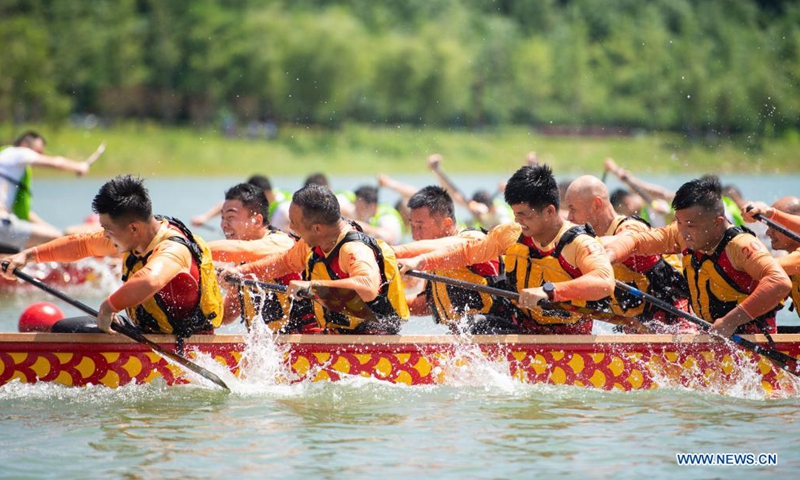People participate in a dragon boat racing at Quzi Cultural Park in Miluo City, central China's Hunan Province, June 13, 2021. A dragon boat racing performance was held here on Sunday to celebrate the upcoming Dragon Boat Festival. (Xinhua/Chen Sihan)