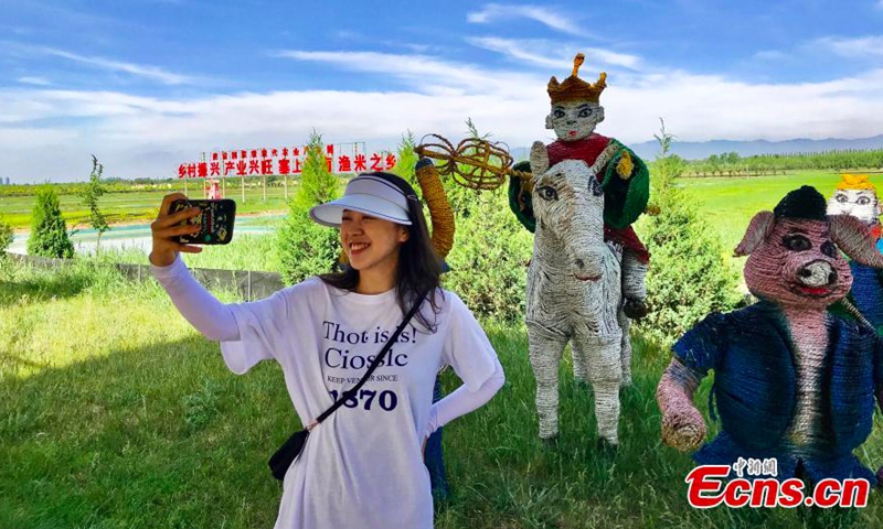 A tourist takes photo at the ecological sightseeing park in Helan County, Yinchuan City, Ningxia, June 10, 2021. (Photo/Li Zeyang)