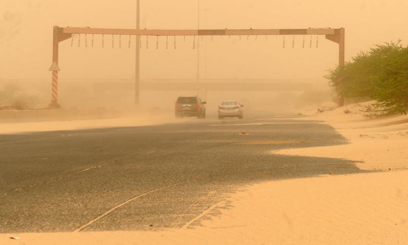 Cars run in dust in Jahra governorate of Kuwait on June 12, 2021. A sand storm engulfed Kuwait on Saturday. (Photo by Asad/Xinhua)