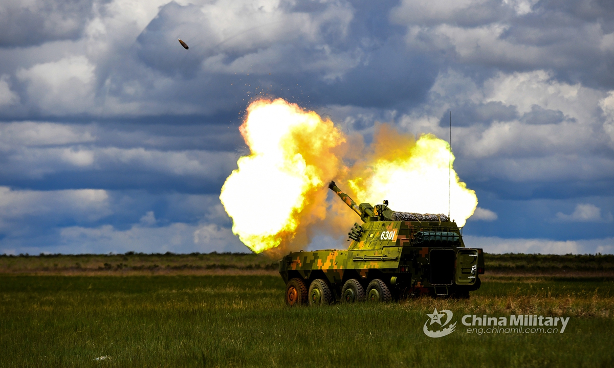 A wheeled self-propelled howitzer attached to a brigade under the PLA 80th Group Army fires a shell during a live-fire drill on June 4, 2021. (eng.chinamil.com.cn/Photo by Guo Daoxiong)
