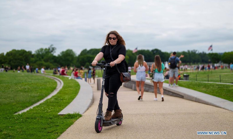 People spend time at the National Mall in Washington D.C., the United States, June 12, 2021. (Photo by Ting Shen/Xinhua)