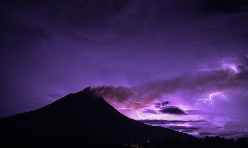 This long-time exposure photo taken on June 12, 2021 shows lightning striking near Mount Sinabung in North Sumatra, Indonesia. (Photo by Sarianto Sembiring/Xinhua)
