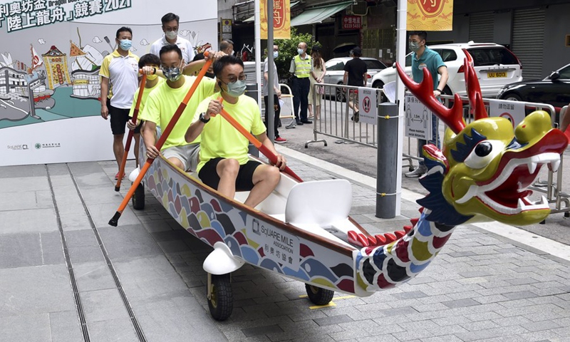 Photo taken on June 13, 2021 in Hong Kong, South China shows a boat race on land held amid COVID-19 in Hong Kong to celebrate the Dragon Boat Festival that falls on Monday this year.(Photo: Xinhua)