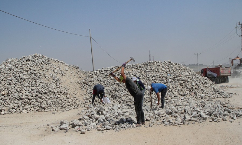 Palestinian workers crush building rubble into gravel for making bricks at a bricks factory in Gaza City, on June 13, 2021.(Photo: Xinhua)