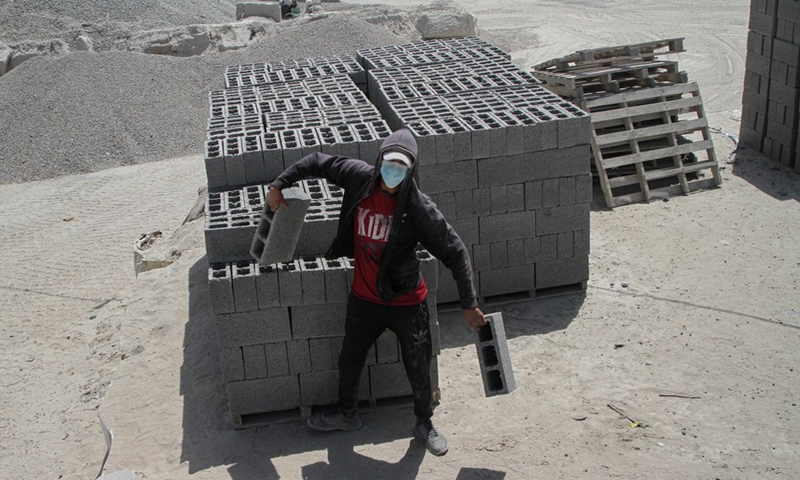 A Palestinian worker moves the ready-to-use bricks made from building rubble at a bricks factory in Gaza City, on June 13, 2021.(Photo: Xinhua)