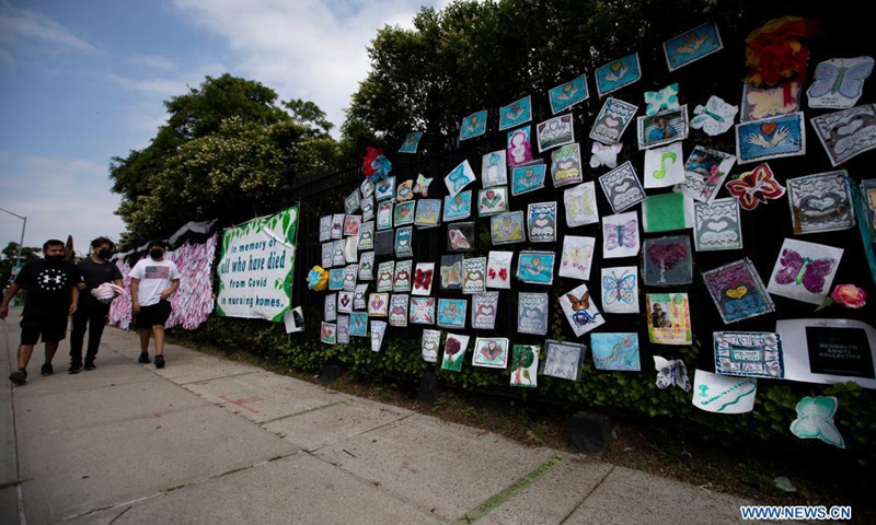 People walk past a memorial installation for those who died of COVID-19 outside Green-Wood Cemetery in New York, the United States, on June 14, 2021. The United States reached the grim milestone of 600,000 coronavirus deaths on Tuesday, according to the Center for Systems Science and Engineering (CSSE) at Johns Hopkins University.(Photo: Xinhua)
