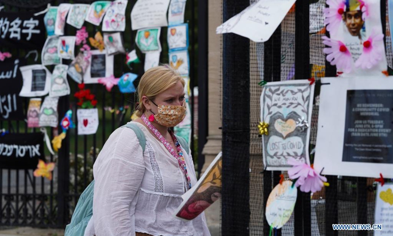 A woman looks at a memorial installation for those who died of COVID-19 outside Green-Wood Cemetery in New York, the United States, on June 14, 2021. The United States reached the grim milestone of 600,000 coronavirus deaths on Tuesday, according to the Center for Systems Science and Engineering (CSSE) at Johns Hopkins University.(Photo: Xinhua)
