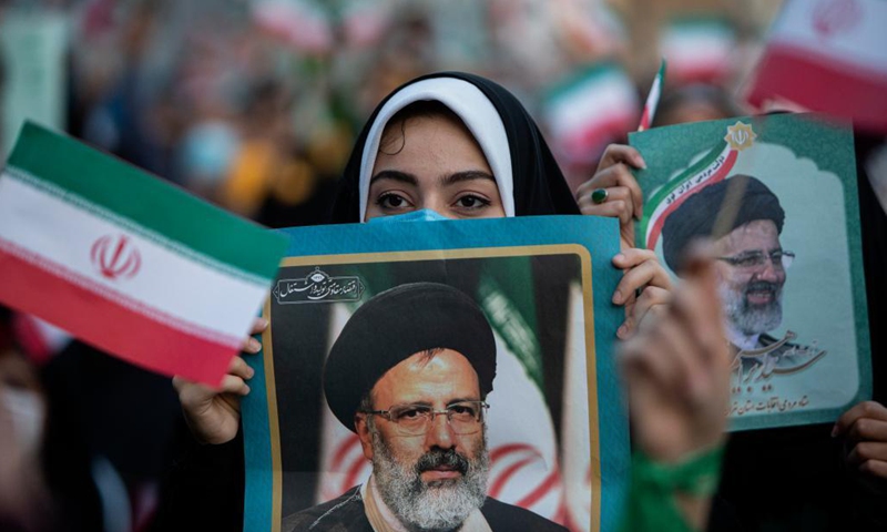 A woman holds a poster as supporters celebrate after Ebrahim Raisi won the presidential election in Tehran, Iran, on June 19, 2021. Judiciary Chief Ebrahim Raisi won Iran's presidential race by securing over 60 percent of votes, the Iranian Interior Ministry announced on Saturday.(Photo: Xinhua)