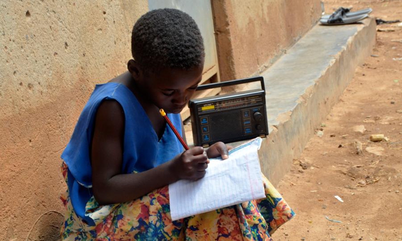 A child listens to a radio program in Kampala, Uganda, June 14, 2021. (Photo: Xinhua)