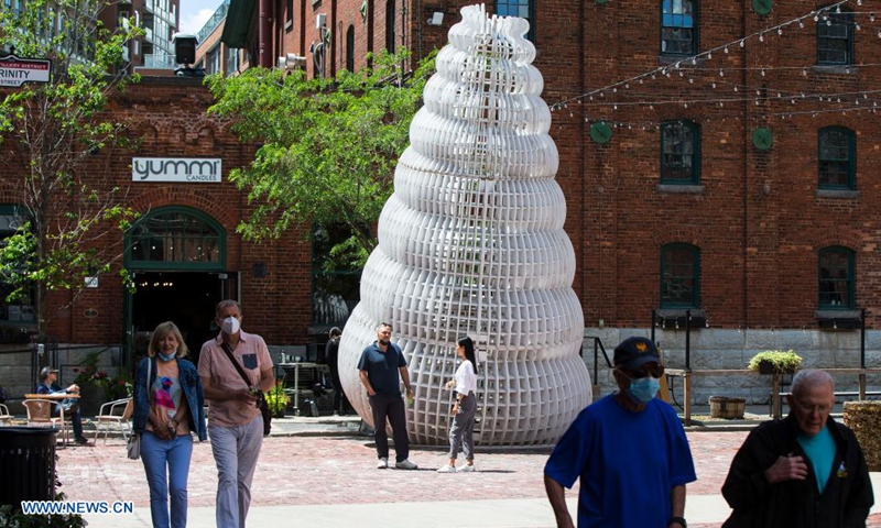 People walk past an art installation during the exhibition of the 2021 Winter Stations international design competition in Toronto, Canada, on June 22, 2021.(Photo: Xinhua)