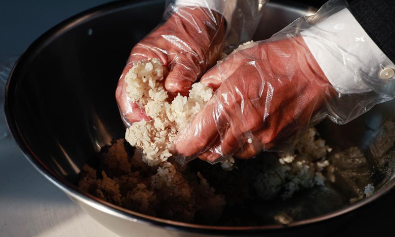 Guests experience making makgeolli at Hwaseong Haenggung Palace in Suwon, South Korea, June 26, 2021. Makgeolli, a traditional Korean alcoholic beverage made from rice, has been listed as South Korea's national intangible cultural heritage recently.(Photo: Xinhua)