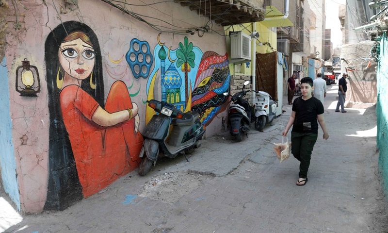 Murals are seen painted on the walls in the old al-Anbariyen slum in Baghdad, Iraq, on June 2, 2021.(Photo: Xinhua)