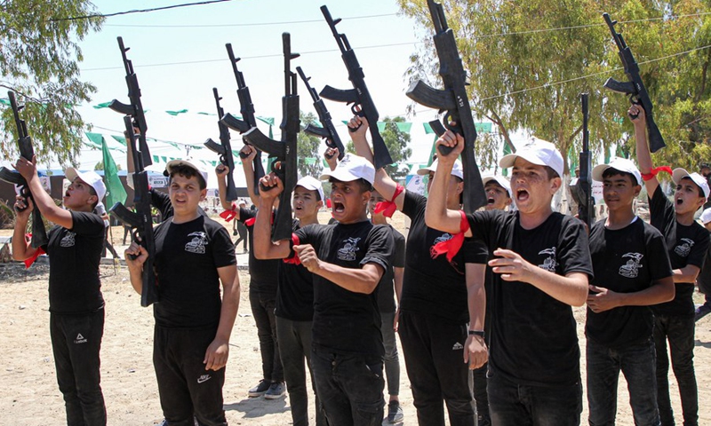 Palestinian teenage boys hold toy guns during a military training course at a summer camp run by Hamas at the Al-Yarmouk military site, east of Gaza City, on June 26, 2021.(Photo: Xinhua)