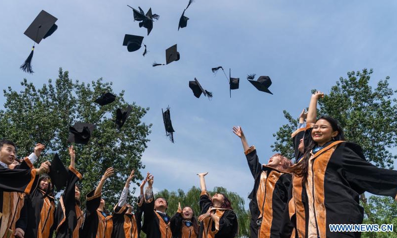 Graduates toss their caps upon graduation at Beijing Foreign Studies University (BFSU) in Beijing, capital of China, July 2, 2021. BFSU, a university well recognized in China for foreign language education, held a guaduation ceremony for its Class of 2021 graduates on Friday.Photo:Xinhua