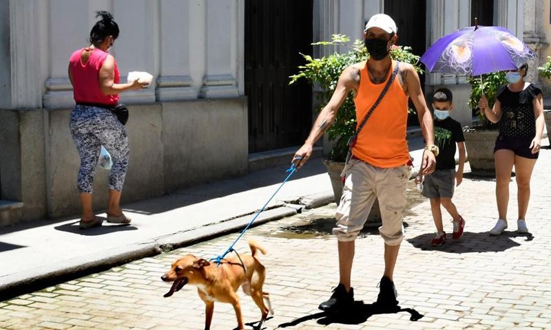 People wearing masks walk on a street in Havana, Cuba, July 2, 2021. Cuba registered 3,308 new COVID-19 infections and 20 more deaths in the last 24 hours, both record numbers for one day, bringing the totals to 197,253 cases and 1,322 deaths, the Ministry of Public Health reported on Friday.Photo:Xinhua