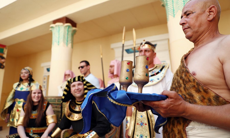 People wearing pharaonic costumes take part in a pharaonic wedding ceremony held to revitalize tourism affected by the COVID-19 pandemic at Pharaonic Village in Giza, Egypt, on July 5, 2021.(Photo: Xinhua)