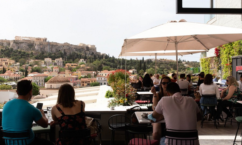 People are seen at a cafe at the foot of the Acropolis, in Athens, Greece, May 3, 2021.(Photo: Xinhua)