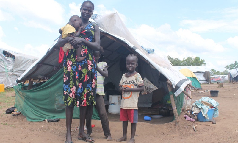 Ayen Gach Awan, a 28-years-old Sudanese woman, and her children pose for a photo outside their temporary shelter in Mangalla, South Sudan, Oct. 23, 2020.(Photo: Xinhua)