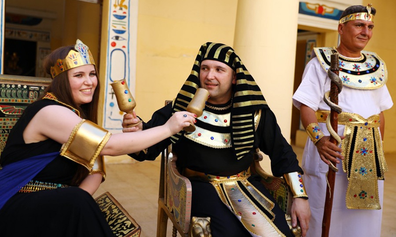 People wearing pharaonic costumes take part in a pharaonic wedding ceremony held to revitalize tourism affected by the COVID-19 pandemic at Pharaonic Village in Giza, Egypt, on July 5, 2021.(Photo: Xinhua)