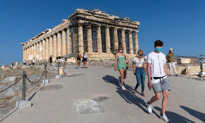 Visitors walk down the new cement walkway nearby the Parthenon temple on the Acropolis hill in Athens, Greece, on June 8, 2021.(Photo: Xinhua)