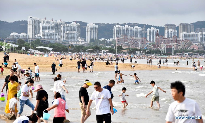 People spend time on the beach of Rizhao City, east China's Shandong Province, July 8, 2021. Photo:Xinhua
