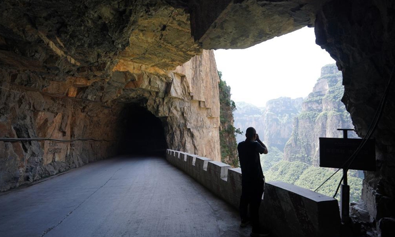 The villagers have spent 15 years excavating a 1,500-meter-long road over the cliff since 1985. The road now attracts many tourists every year.Photo:Xinhua