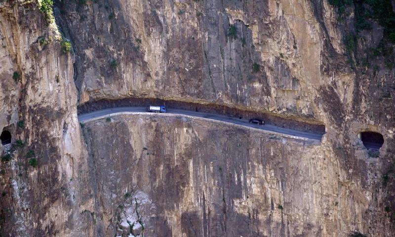 Vehicles run on the road over the cliff in Pingshun County, north China's Shanxi Province, July 9, 2021. Tucked away in the steep Taihang Mountain, Shenlongwan Village of Pingshun County has long suffered from poor transport infrastructure due to the rugged mountainous terrain.Photo:Xinhua