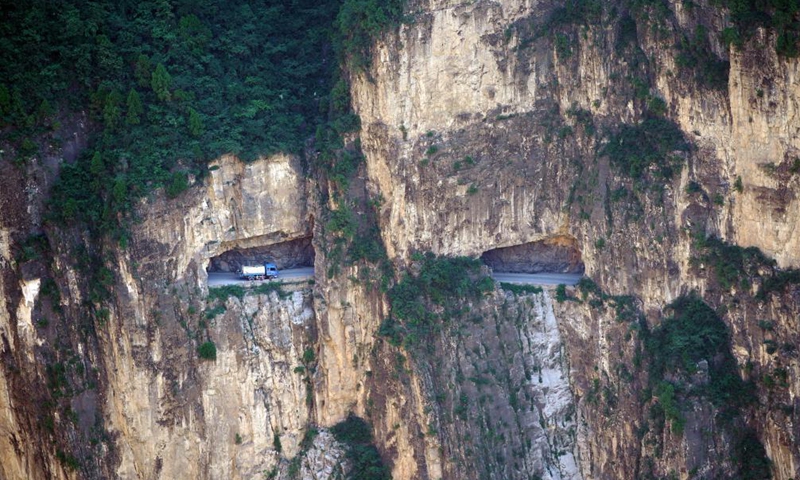 A truck runs on the road over the cliff in Pingshun County, north China's Shanxi Province, July 9, 2021. Tucked away in the steep Taihang Mountain, Shenlongwan Village of Pingshun County has long suffered from poor transport infrastructure due to the rugged mountainous terrain.Photo:Xinhua